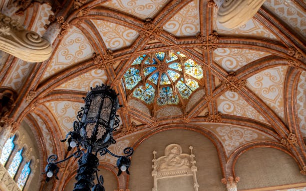 Interior of Recinte Modernista de Sant Pau with Gothic dome and stained glass.