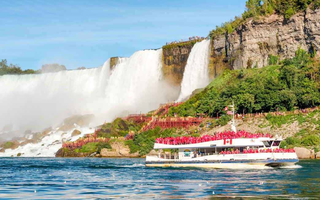 Tourists on Hornblower boat near Horseshoe Falls, Niagara Falls, Canada.
