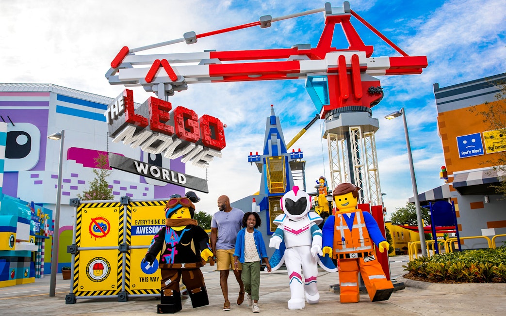 Family walking with LEGO characters at The LEGO Movie World in San Diego.
