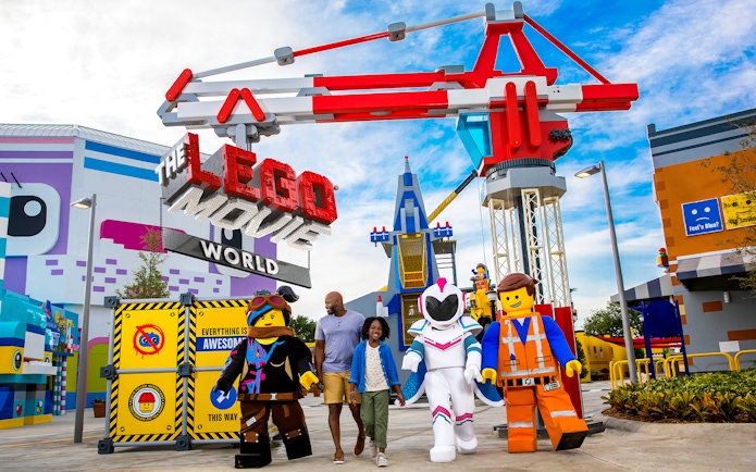 Family walking with LEGO characters at The LEGO Movie World in San Diego.