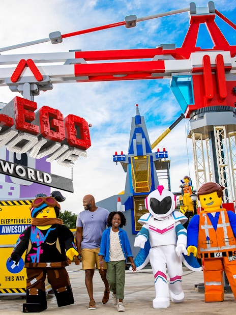 Family walking with LEGO characters at The LEGO Movie World in San Diego.