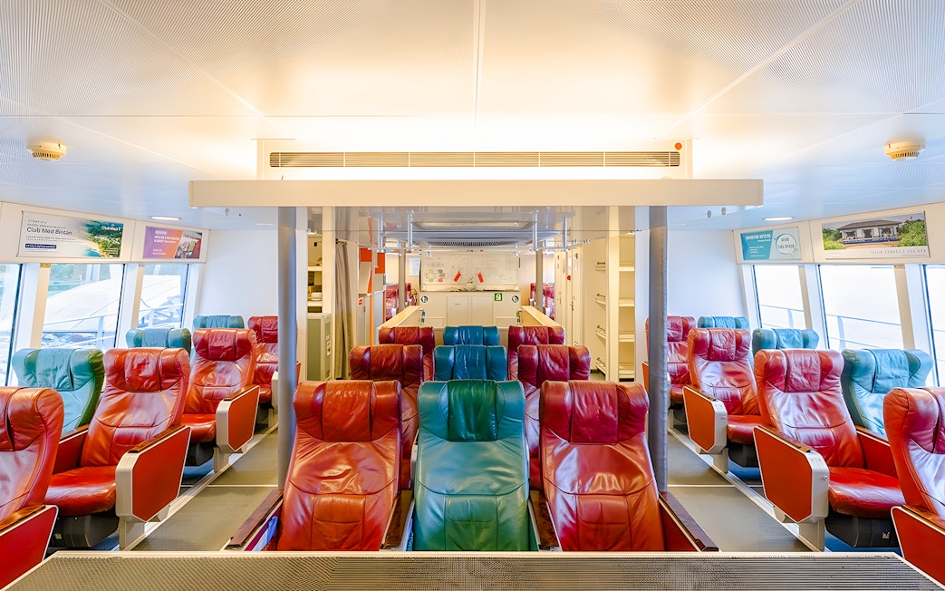 Ferry interior with colorful seats on the Singapore to Bintan Resorts route.