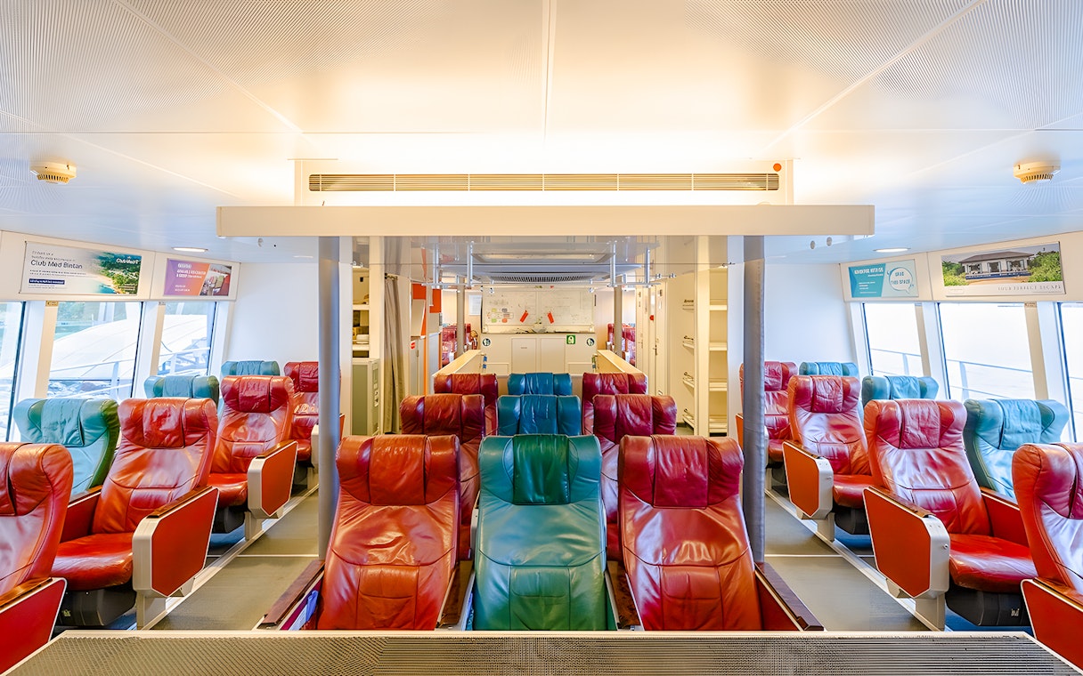 Ferry interior with colorful seats on the Singapore to Bintan Resorts route.