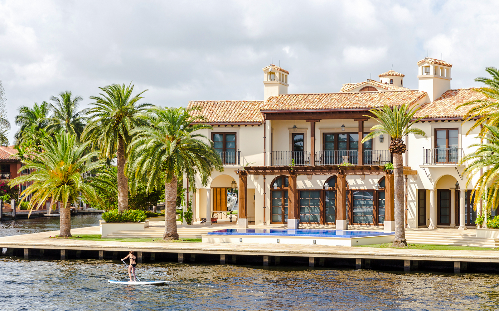 Luxury mansion with palm trees by the water in Fort Lauderdale, Florida.