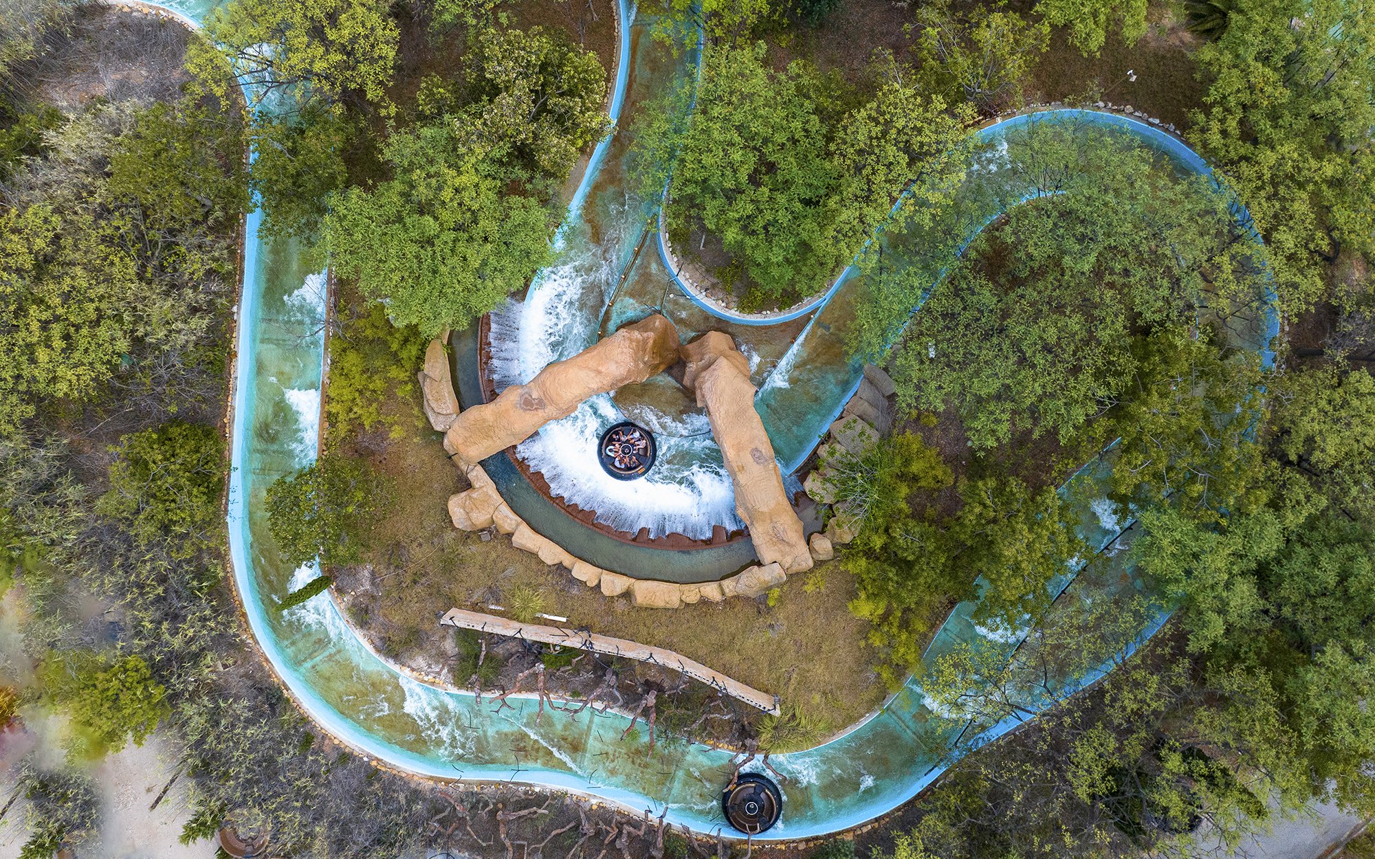 Aerial view of water ride surrounded by trees at Terra Mitica Benidorm.