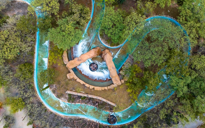 Aerial view of water ride surrounded by trees at Terra Mitica Benidorm.