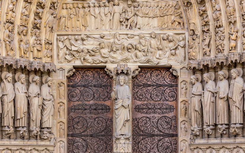 Notre Dame Cathedral facade with detailed sculptures, Paris.