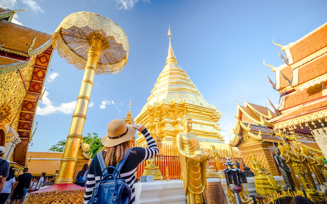 Girl admiring Wat Phra That Doi Suthep temple in Chiang Mai, Thailand.