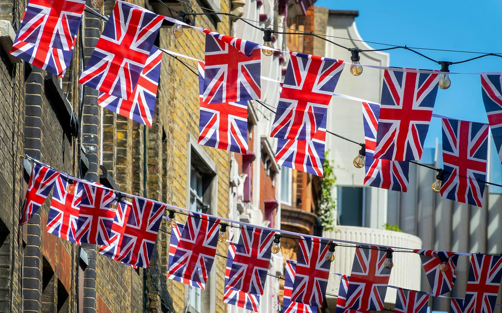 Union Jack flags hanging in a London street for coronation day celebration.
