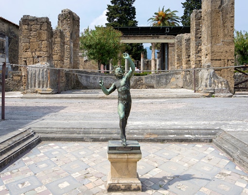 Bronze statue in the atrium of the House of the Faun, Pompeii Ruins.