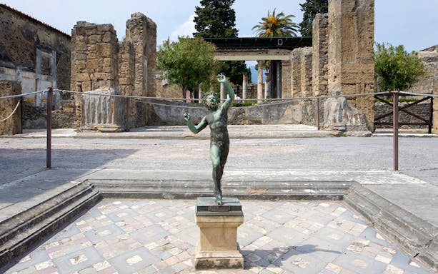 Bronze statue in the atrium of the House of the Faun, Pompeii Ruins.