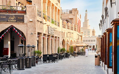 Souq Waqif in Doha, Qatar, with traditional architecture and outdoor cafes.