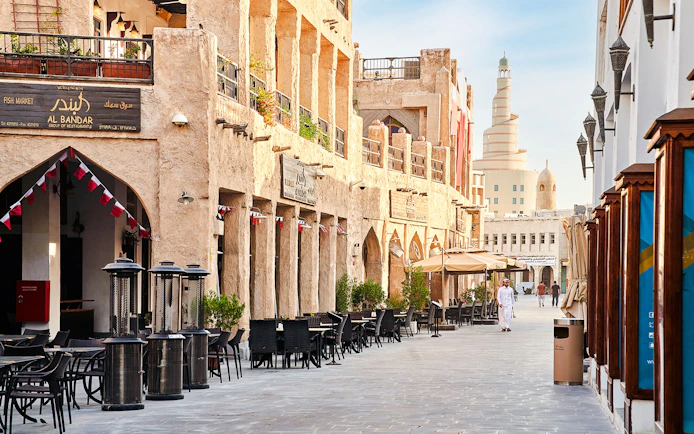 Souq Waqif in Doha, Qatar, with traditional architecture and outdoor cafes.
