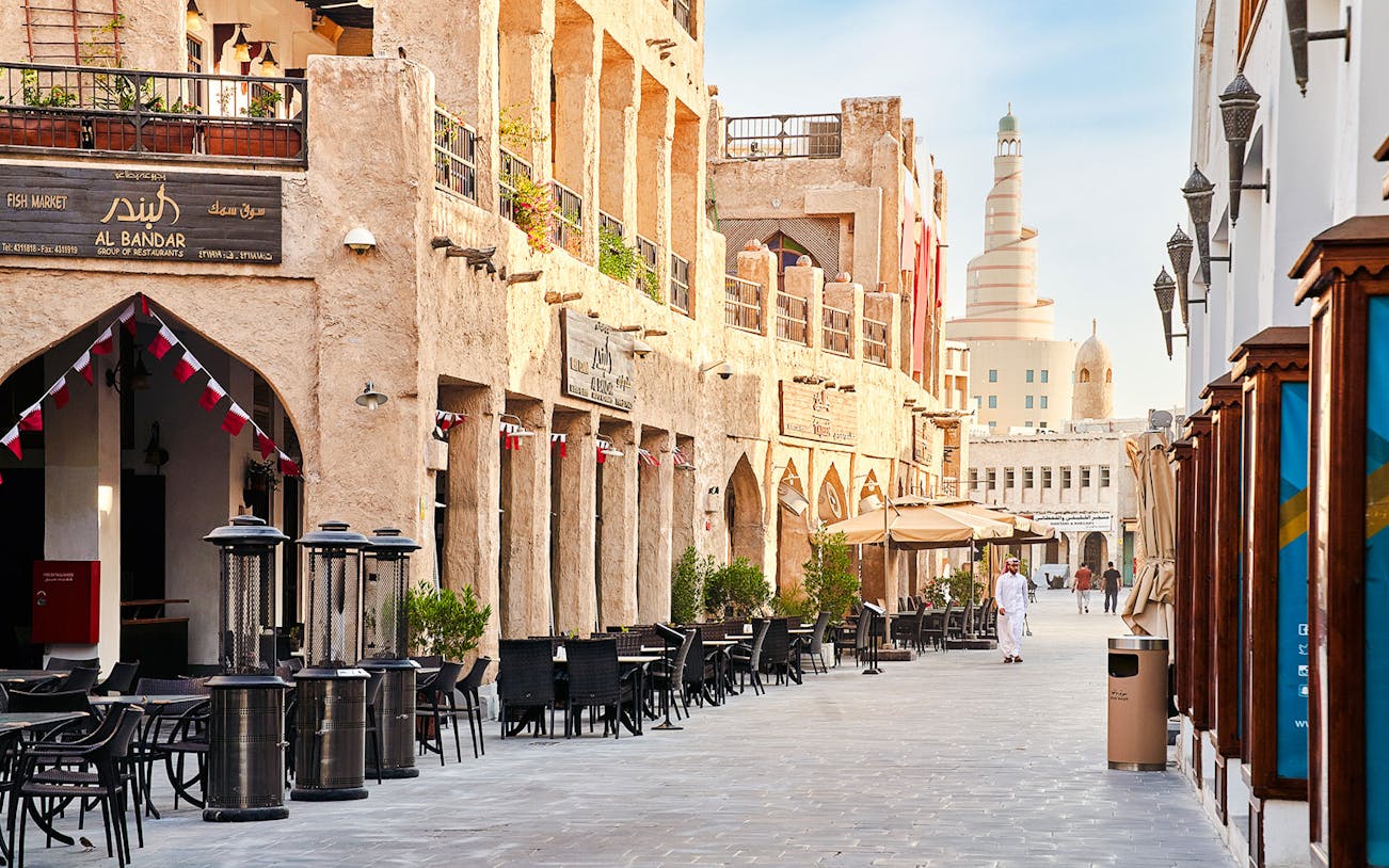Souq Waqif in Doha, Qatar, with traditional architecture and outdoor cafes.