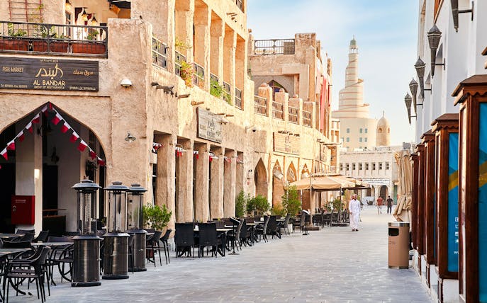 Souq Waqif in Doha, Qatar, with traditional architecture and outdoor cafes.