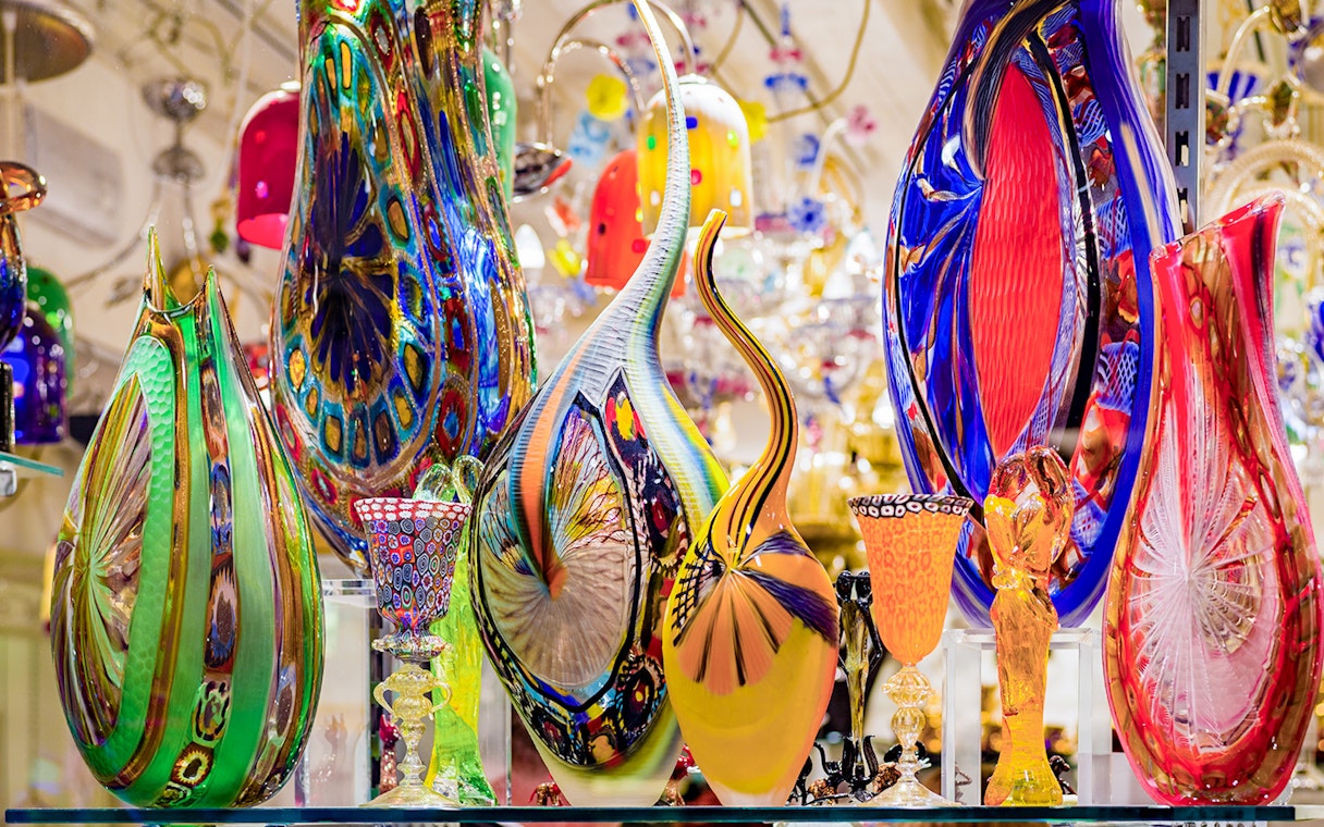 Colorful Murano glass artifacts displayed at a museum exhibit.