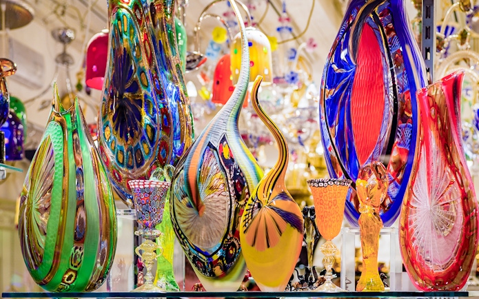 Colorful Murano glass artifacts displayed at a museum exhibit.