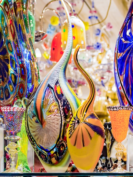 Colorful Murano glass artifacts displayed at a museum exhibit.