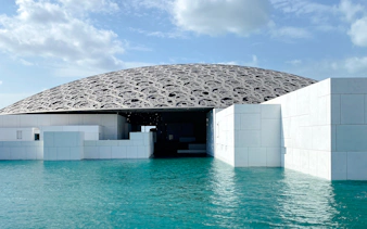 Louvre Abu Dhabi dome over water, part of Abu Dhabi tour from Dubai.