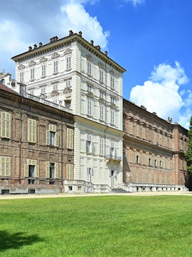 Musei Reali facade in Turin, Italy, with expansive green lawn.