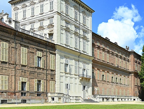 Musei Reali facade in Turin, Italy, with expansive green lawn.