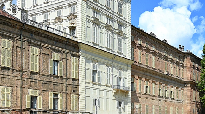 Musei Reali facade in Turin, Italy, with expansive green lawn.