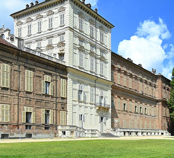 Musei Reali facade in Turin, Italy, with expansive green lawn.