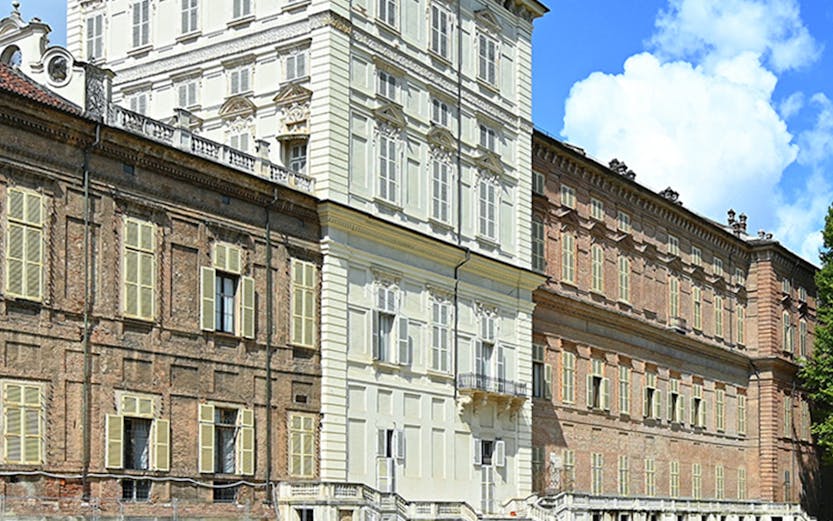 Musei Reali facade in Turin, Italy, with expansive green lawn.