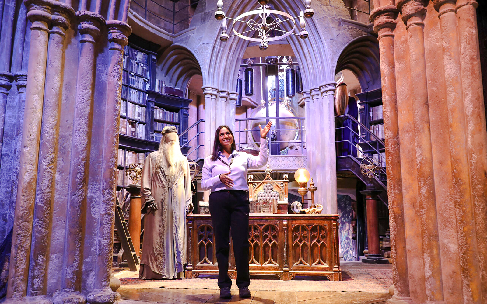 Guide presenting Dumbledore's office at Harry Potter Warner Bros Studio Tour.