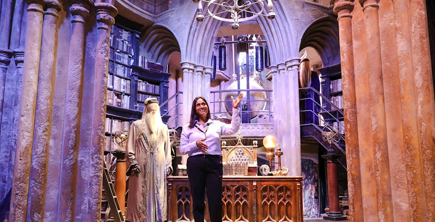 Guide presenting Dumbledore's office at Harry Potter Warner Bros Studio Tour.