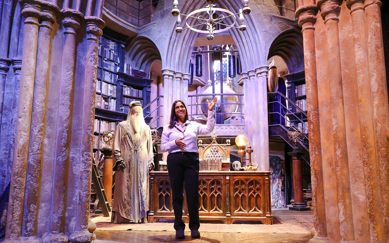Guide presenting Dumbledore's office at Harry Potter Warner Bros Studio Tour.