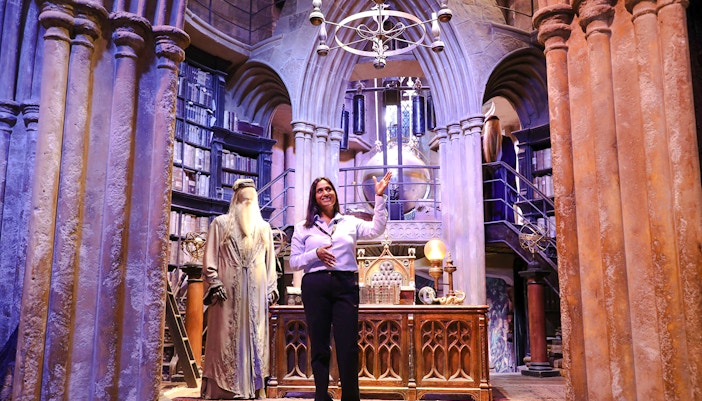 Guide presenting Dumbledore's office at Harry Potter Warner Bros Studio Tour.