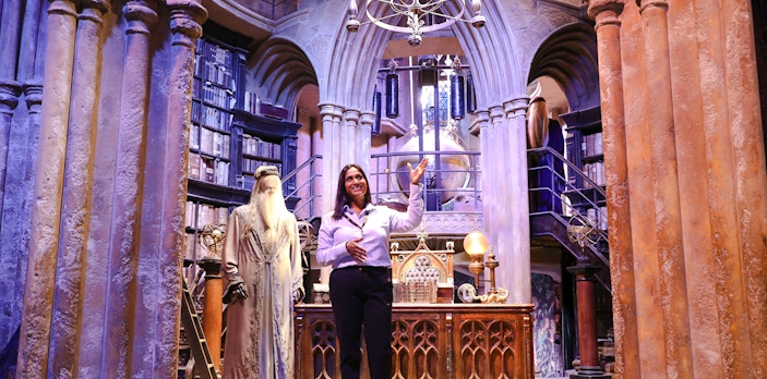 Guide presenting Dumbledore's office at Harry Potter Warner Bros Studio Tour.