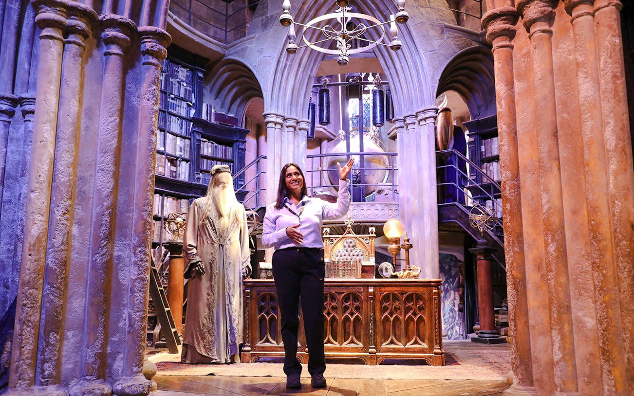 Guide presenting Dumbledore's office at Harry Potter Warner Bros Studio Tour.