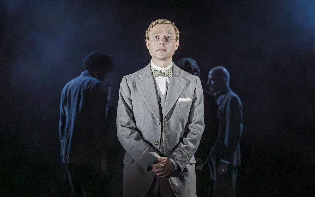 Performer in Grace Pervades West End show with cast in background.
