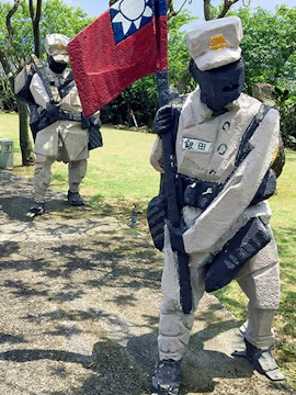 Sculptures of soldiers holding a flag at Ju Ming Museum, Taiwan.