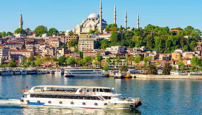 Suleymaniye Mosque overlooking Golden Horn bay with a boat in Istanbul, Turkey.