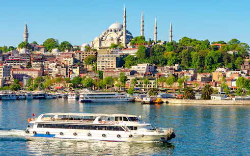Suleymaniye Mosque overlooking Golden Horn bay with a boat in Istanbul, Turkey.