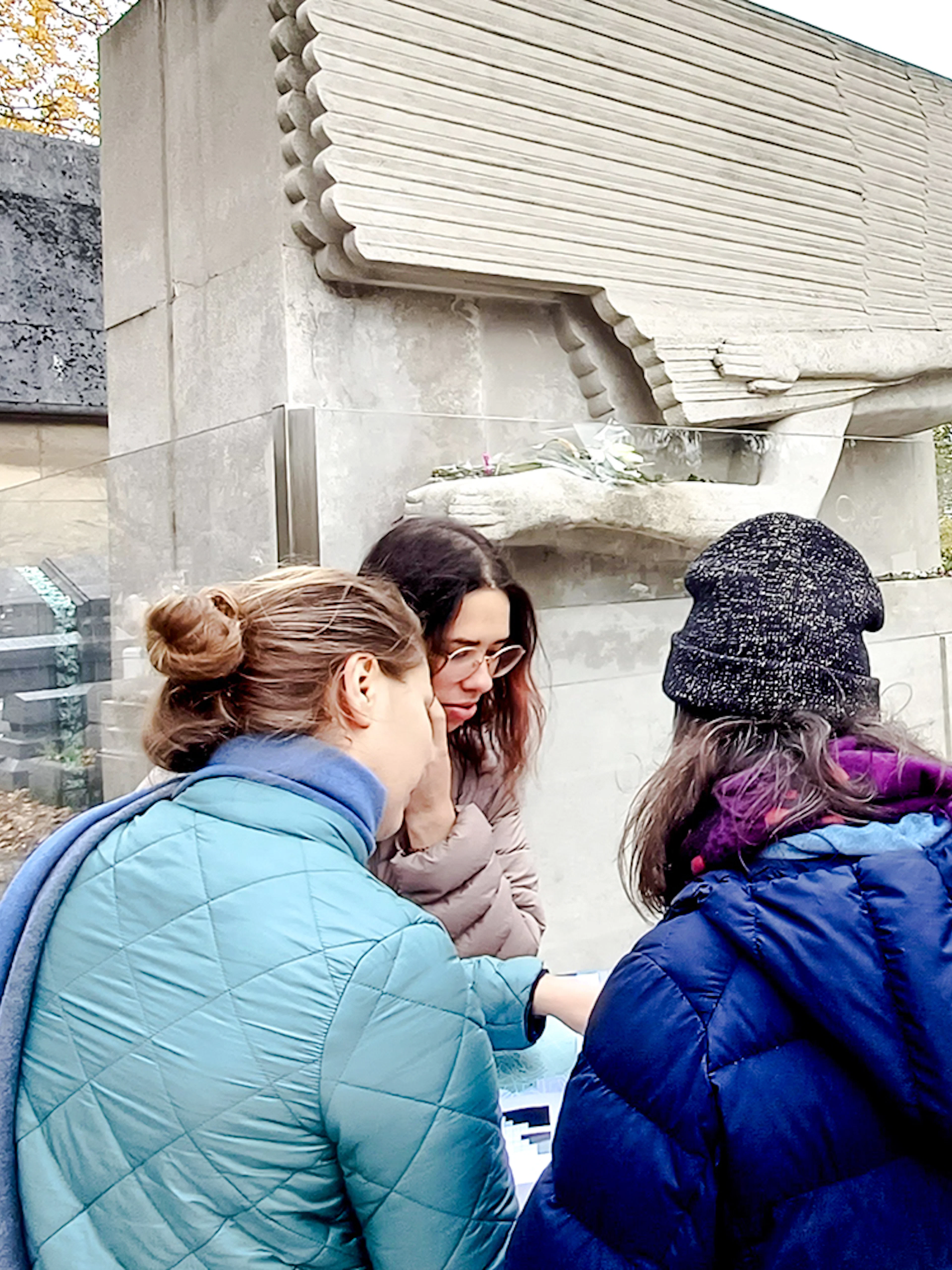 Visitors exploring Père Lachaise Cemetery in Paris, France.