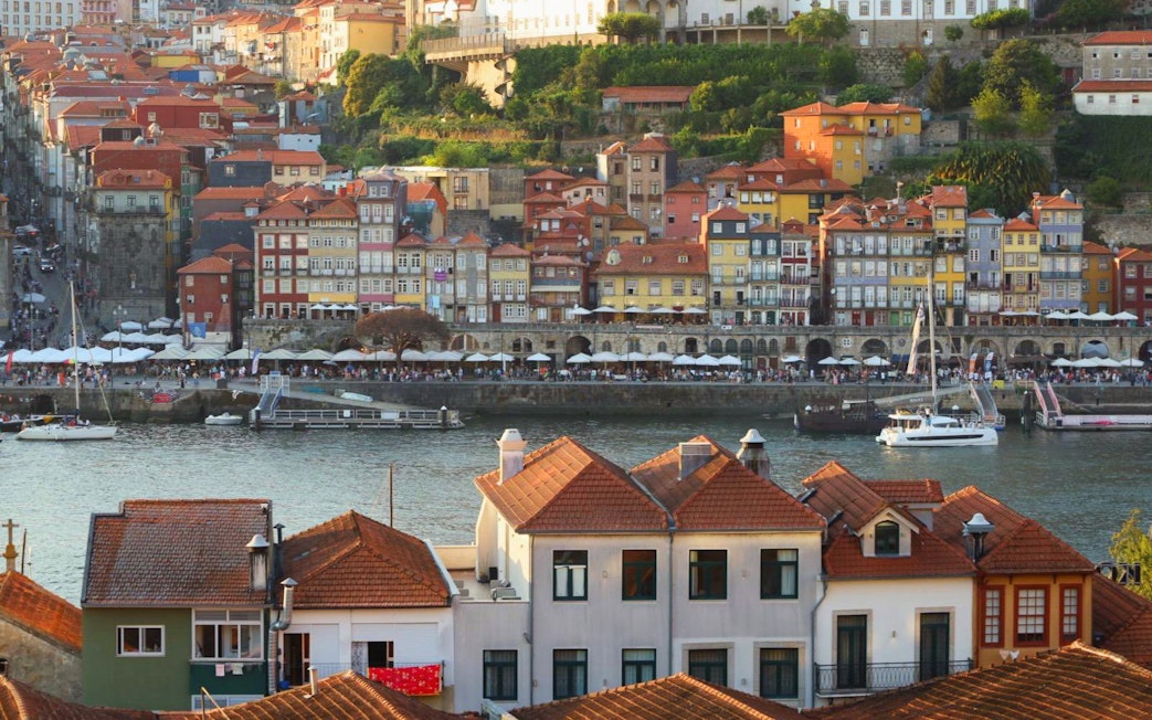 Colorful buildings along Porto river with boats near the boarding point.