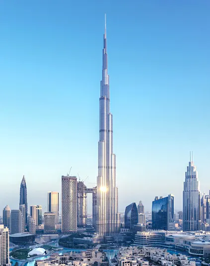 Burj Khalifa towering over Dubai skyline with surrounding skyscrapers.
