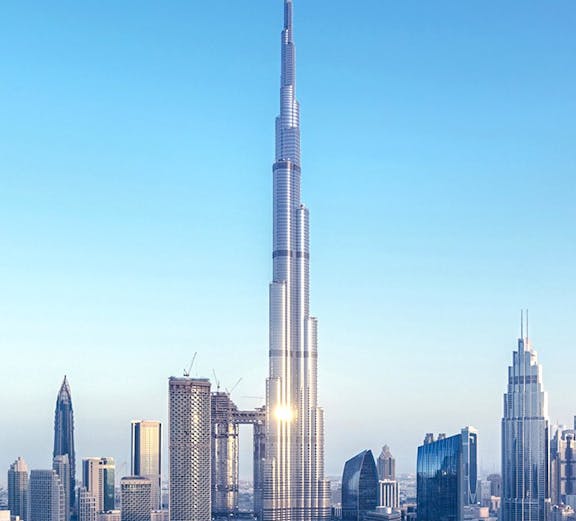Burj Khalifa towering over Dubai skyline with surrounding skyscrapers.