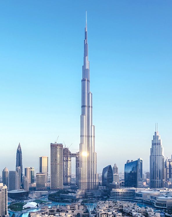 Burj Khalifa towering over Dubai skyline with surrounding skyscrapers.