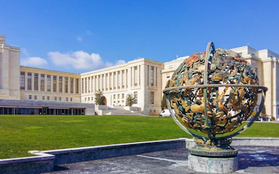 Palace of Nations in Geneva with Celestial Sphere sculpture in foreground.