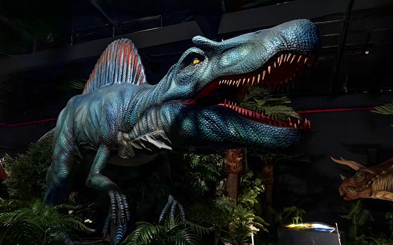 Dinosaur exhibit inside Dinosaur Encounter World, Perak, featuring a large animatronic dinosaur.