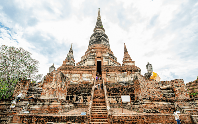 Wat Yai Chai Mongkhon temple with central chedi and Buddha statues, Ayutthaya, Thailand.