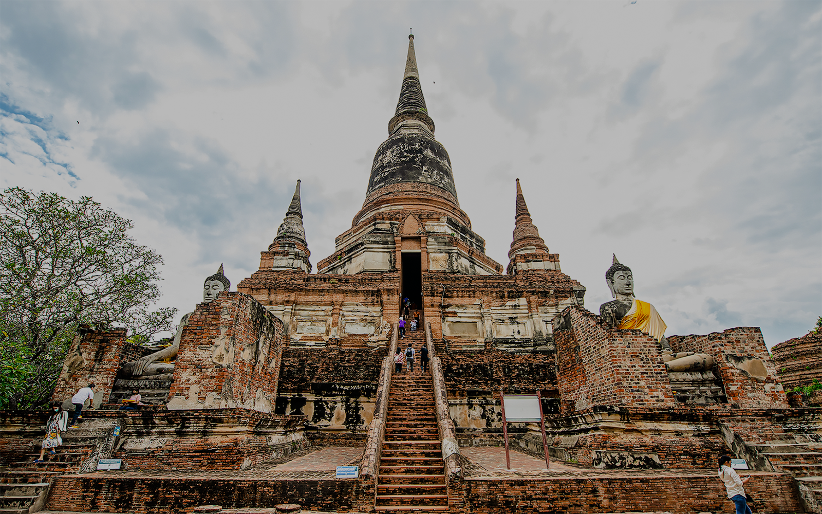 Wat Yai Chai Mongkhon temple with central chedi and Buddha statues, Ayutthaya, Thailand.