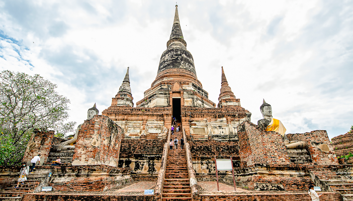 Wat Yai Chai Mongkhon temple with central chedi and Buddha statues, Ayutthaya, Thailand.