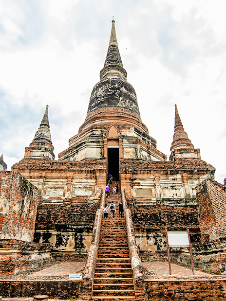 Wat Yai Chai Mongkhon temple with central chedi and Buddha statues, Ayutthaya, Thailand.