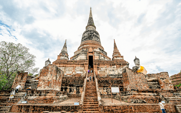 Wat Yai Chai Mongkhon temple with central chedi and Buddha statues, Ayutthaya, Thailand.